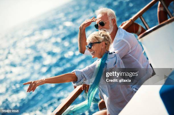 senior couple on a sailing cruise. - sailing couple stock pictures, royalty-free photos & images