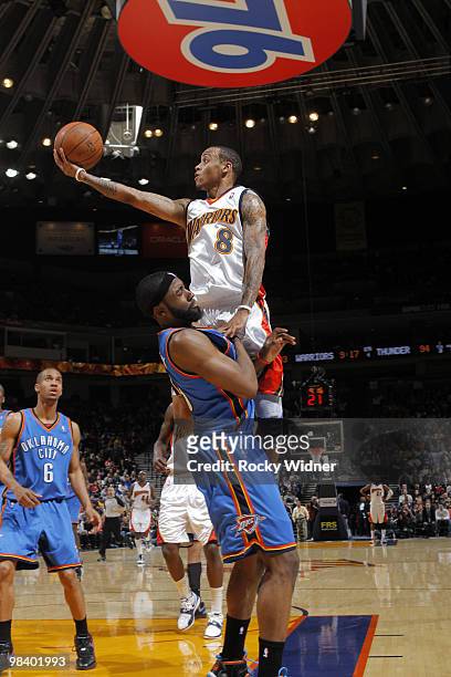 Monta Ellis of the Golden State Warriors lays the ball up over James Harden of the Oklahoma City Thunder on April 11, 2010 at Oracle Arena in...