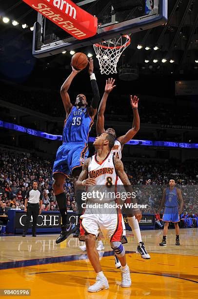 Kevin Durant of the Oklahoma City Thunder shoots the ball over Monta Ellis and Anthony Tolliver of the Golden State Warriors on April 11, 2010 at...