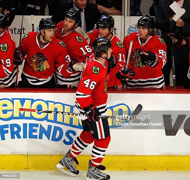 Colin Fraser of the Chicago Blackhawks receives congratulations from teammates including Kris Versteeg, Andrew Ladd, John Madden and Patrick Kane...