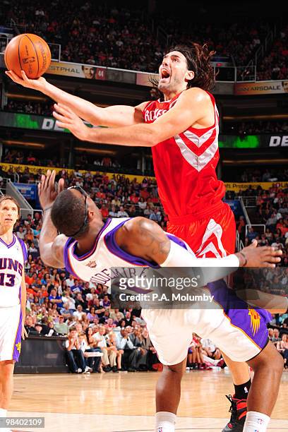 Trevor Ariza of the Houston Rockets commits an offensive foul against Amare Stoudemire of the Phoenix Suns in an NBA Game played on April 11, 2010 at...