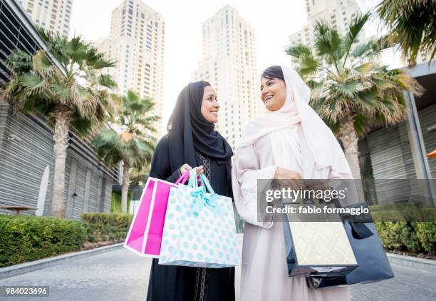 two arabian girlfriends bonding and having fun - agal stock pictures, royalty-free photos & images