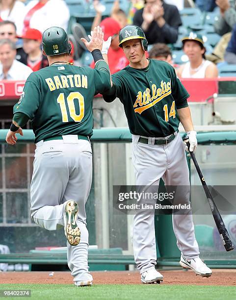 Daric Barton of the Oakland Athletics scores in the 9th inning against the Los Angeles Angels of Anaheim at Angel Stadium of Anaheim on April 11,...