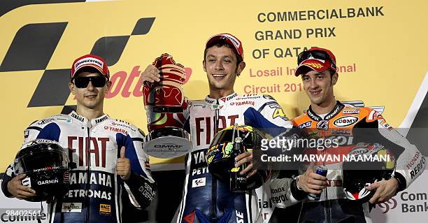 Nine-time Italian world champion Valentino Rossi of Fiat Yamaha Team jubilates on the podium with teammate Jorge Lorenzo and his Italian conpatriot...