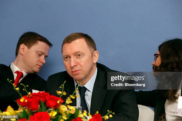 Oleg Deripaska, chief executive officer of United Co. Rusal Plc, center, attends the company's 2009 annual results news conference in Hong Kong,...