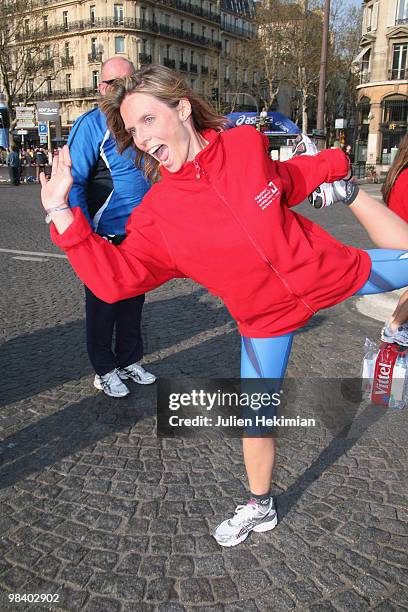 Sylvie Tellier stretches after her run for the 'Mecenat Chirurgie Cardiaque' association during the Paris marathon on April 11, 2010 in Paris, France.