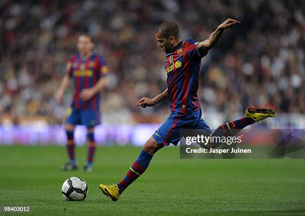 Daniel Alves of FC Barcelona strikes a free kick during the La Liga match between Real Madrid and Barcelona at the Estadio Santiago Bernabeu on April...