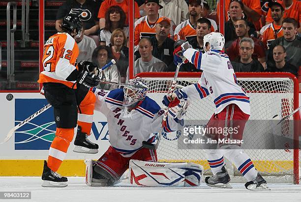 Henrik Lundqvist of the New York Rangers makes a save under pressure from Simon Gagne of the Philadelphia Flyers on April 11, 2010 at Wachovia Center...