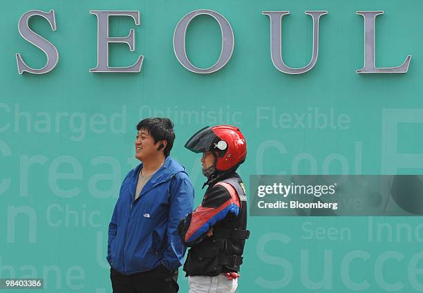 Deliverymen wait for customers in Seoul, South Korea, on Monday, April 12, 2010. South Korea's economy will expand this year at the fastest pace...