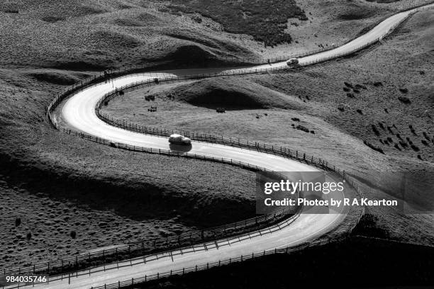 cars on a bendy road in the hills of derbyshire - edale stock pictures, royalty-free photos & images