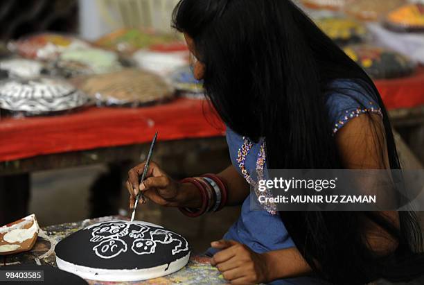 Dhaka University Art Institute student paints masks for Bengali New Year in Dhaka on April 12, 2010. The Bengali calendar is solar, with the year...