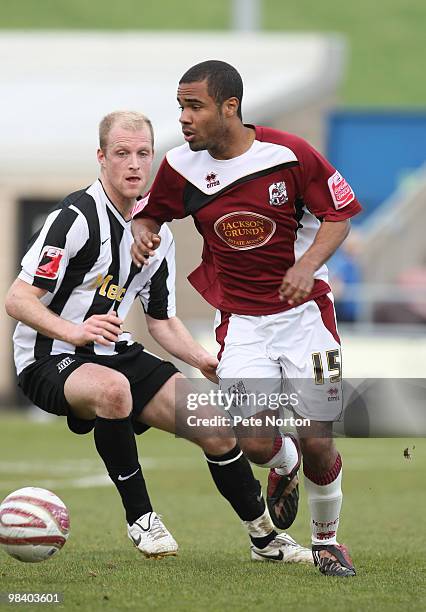 Alex Dyer of Northampton Town looks to move past Neal Bishop of Notts County during the Coca Cola League Two Match between Northampton Town and Notts...