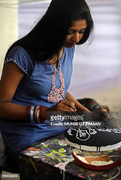 Dhaka University Art Institute student paints masks for Bengali New Year in Dhaka on April 12, 2010. The Bengali calendar is solar, with the year...