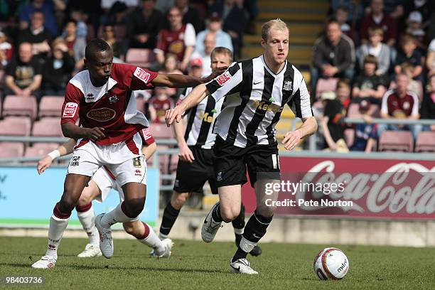 Neal Bishop of Notts County moves away with the ball from Abdul Osman of Northampton Town during the Coca Cola League Two Match between Northampton...