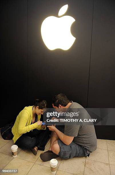 Brittany and Dan Wyman wait in line to be one of the first customers for the iPad at the Apple Store at West Farms Mall in Farmington, Connecticut,...