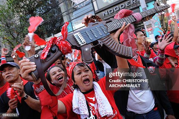 An anti-government 'Red shirt' protester displays a rifle-shaped guitar during a protest outside Thai Prime Minister Abhisit Vejjajiva's residence...