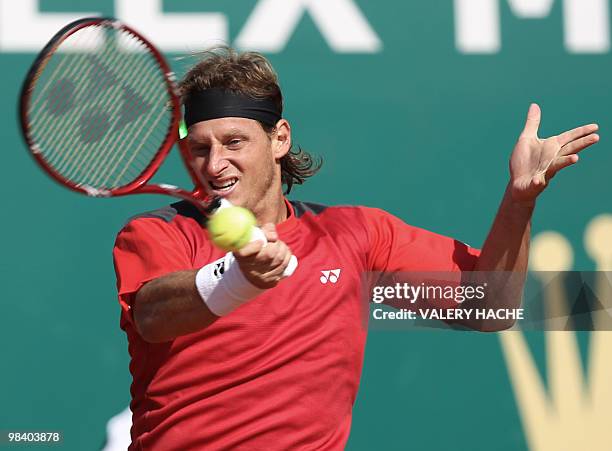 Agentinian David Nalbandian hits a return to his German opponent Andreas Beck during the Monte-Carlo ATP Masters Series Tournament tennis match, on...
