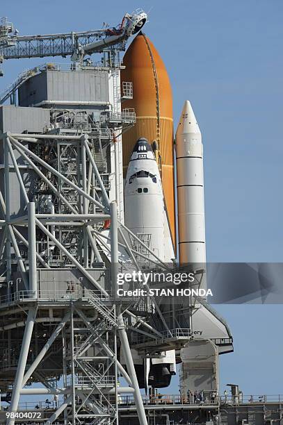 The Rotating Service Structure that protects the space shuttle Discovery is rolled back April 4, 2010 as preparations are made for an early morning...