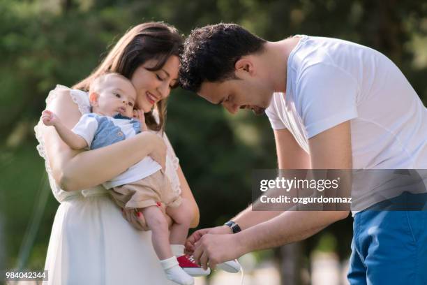 young family with baby boy - ozgurdonmaz stock pictures, royalty-free photos & images