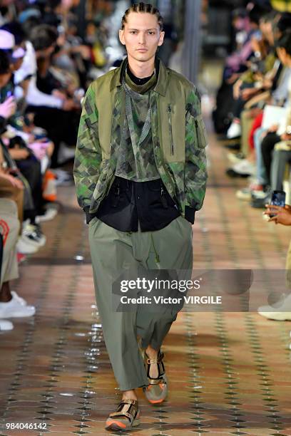 Model walks the runway during the White Mountaineering Menswear Spring/Summer 2019 fashion show as part of Paris Fashion Week on June 23, 2018 in...