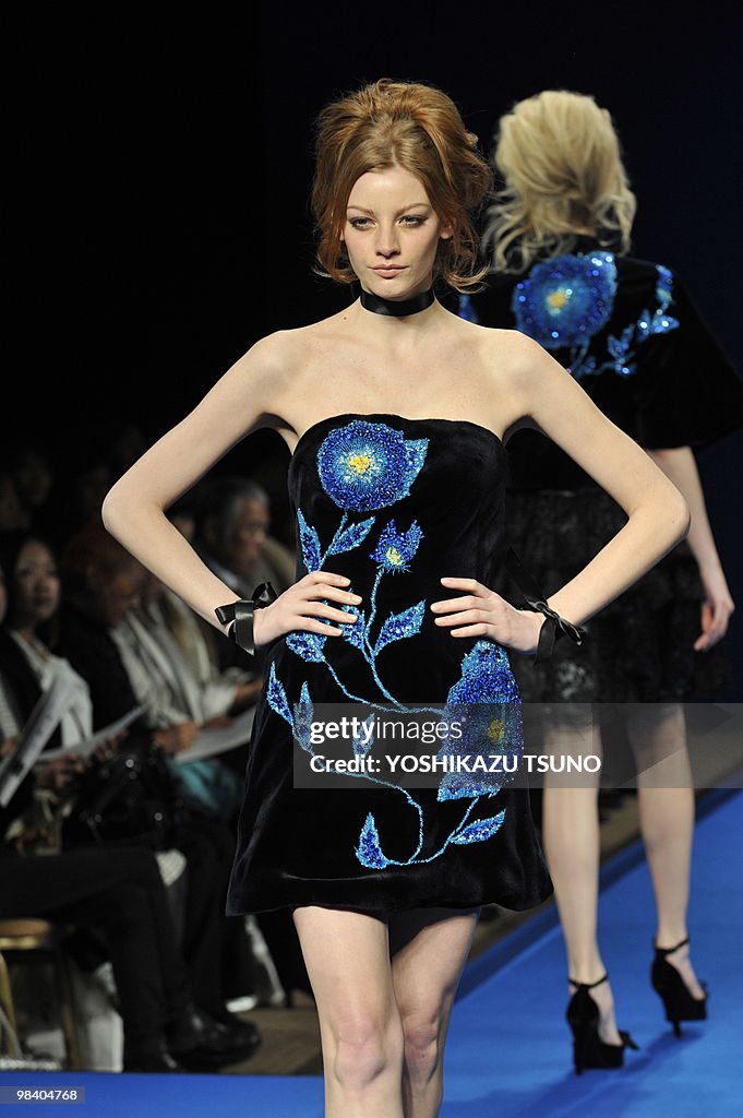 A model displays a mink one-piece with e