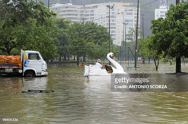 Man pedals a swan paddle boat in a flooded parking lott in front of the Rio de Janeiro's landmark Rodrigo de Freitas lagoon Rio de Janeiro, on April...