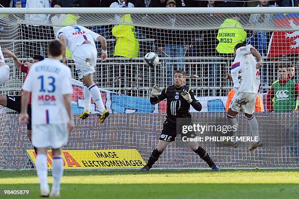 Lyon's Brazilian defender Cris scores with a header despite Lille's French goalkeeper Michael Landreau during the French L1 football match Lyon vs....