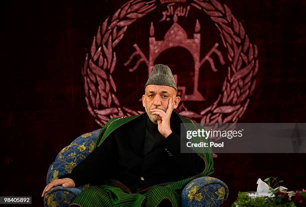 Afghan President Hamid Karzai listens during a meeting with elders on April 11, 2010 in Kunduz, Afghanistan. President Karzai urged Taliban...