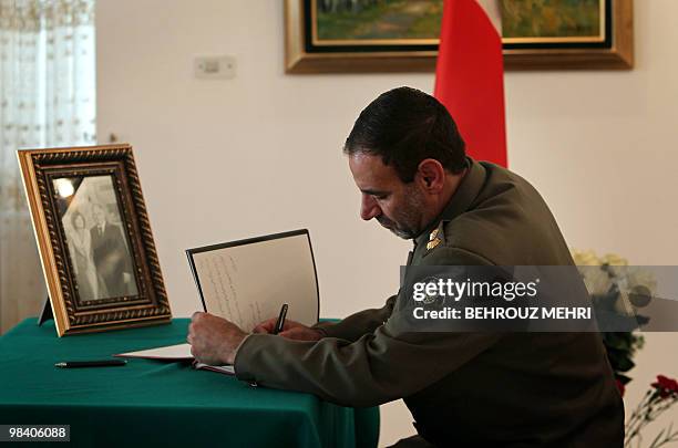 Iranian army Colonel Majid Moazami Goudarzi signs a book of condolences dedicated to late Polish president Lech Kaczynski and his wife Maria...