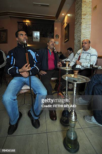 Tunisians smoke chicha in the Saint cafe on April 7, 2010 in Tunis. AFP PHOTO FETHI BELAID