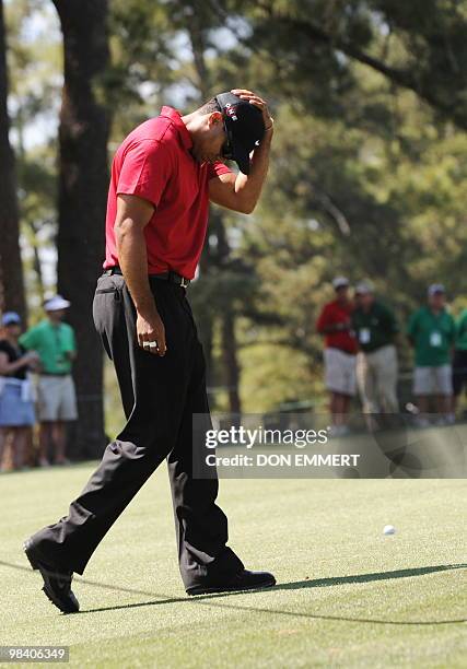 Tiger Woods of the US arrives on the 9th hole fairway to make his approach to the 1st hole during the final round of the Masters Golf Tournament at...