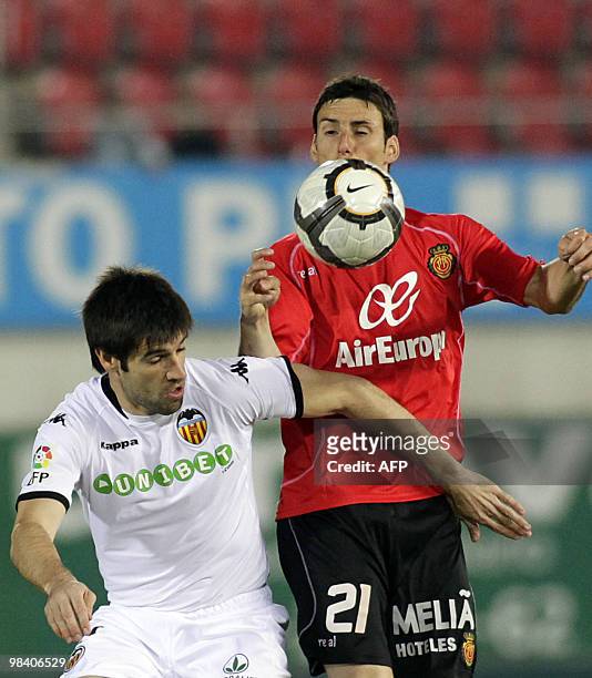 Mallorca's forward Aritz Aduriz vies with Valencia's captain and defender Carlos Marchena during their Spanish League football match at the Ono...