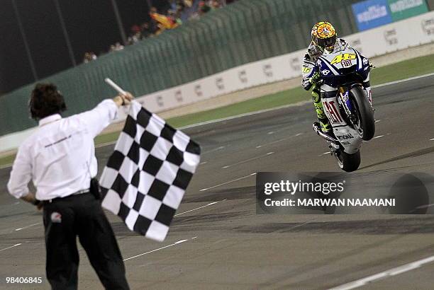 Nine-time Italian world champion Valentino Rossi of Fiat Yamaha team parades as he wins the MotoGP final race at the Losail International Circuit in...