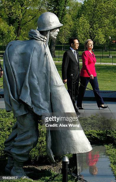 Korean President Lee Myung-bak , accompanied by U.S. Secretary of State Hillary Rodham Clinton, visits the Korean War Memorial for a wreath laying to...