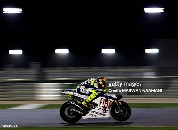 Nine-time Italian world champion Valentino Rossi of Fiat Yamaha team races in the MotoGP final race at the Losail International Circuit in Doha on...