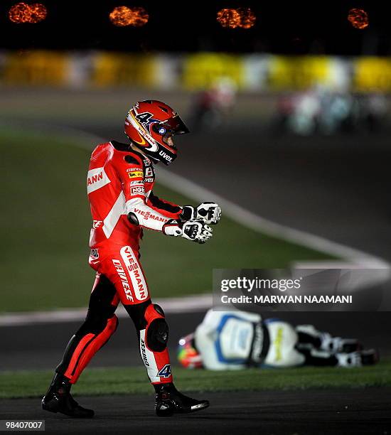 German Stephan Bradel of Viessmann Kiefer Racing gestures after he walks out from circuit after crashing in the first lap of the Moto2 final race at...
