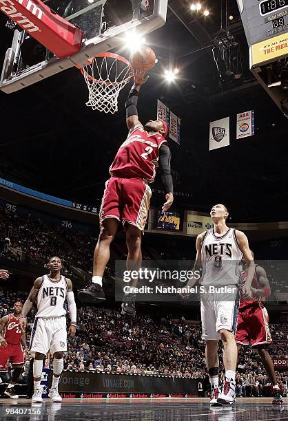 Mo Williams of the Cleveland Cavaliers shoots a layup against Terrence Williams and Yi Jianlian of the New Jersey Nets during the game at the IZOD...