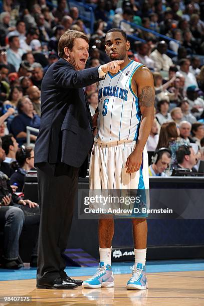 Marcus Thornton of the New Orleans Hornets listens to instructions by assistant coach Tim Floyd during the game against the Cleveland Cavaliers at...