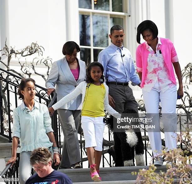 President Barack Obama, first lady Michelle, first dog Bo, daughters Sasha and Malia, and Marian Robinson, mother of Mrs Obama, walk down the stairs...