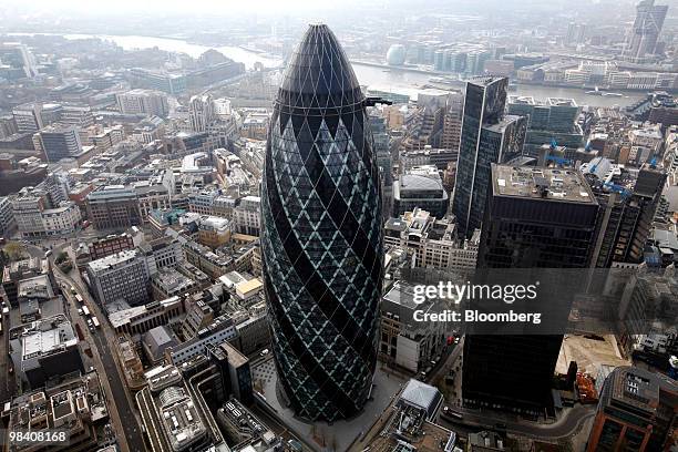 The Swiss Re Insurance building, also known as "the Gherkin", center, and the headquarters of Aviva Plc, St. Helen's house, right, stand in the...