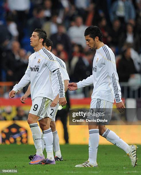 Cristiano Ronaldo and Ezequiel Garay of Real Madrid leave the pitch after Real lost 2-0 to Barcelona in the La Liga match between Real Madrid and...