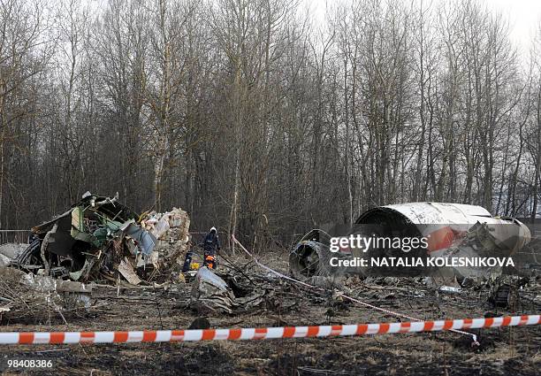 Russian rescuers inspect the wreckage of a Polish government Tupolev Tu-154 aircraft which crashed on April 10 near Smolensk airport, on April 11,...