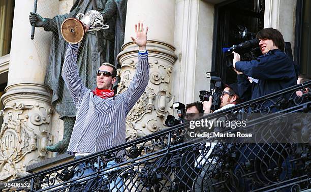 Pascal Hens of Hamburg celebrates with the cup at the Hamburg townhall after winning the DHB German Cup final match between HSV Handball and Rhein...