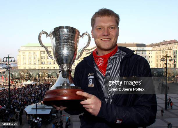 Johannes Bitter of Hamburg celebrates with the cup at the Hamburg townhall after winning the DHB German Cup final match between HSV Handball and...