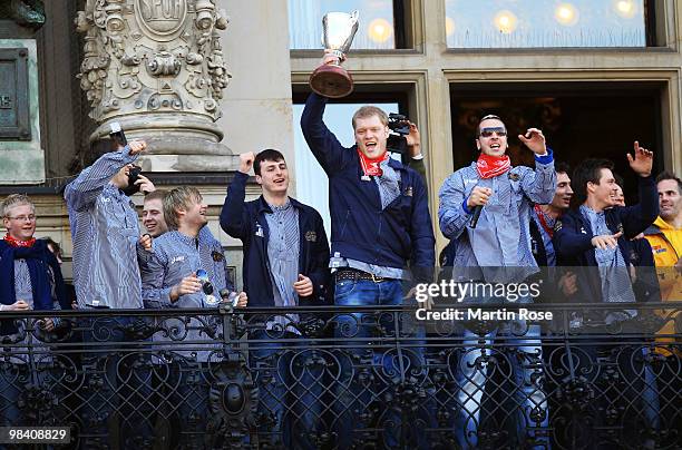 Johannes Bitter of Hamburg celebrates with his team mates with the cup at the Hamburg townhall after winning the DHB German Cup final match between...