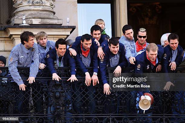 The team of Hamburg celebrate with the cup at the Hamburg townhall after winning the DHB German Cup final match between HSV Handball and Rhein Neckar...