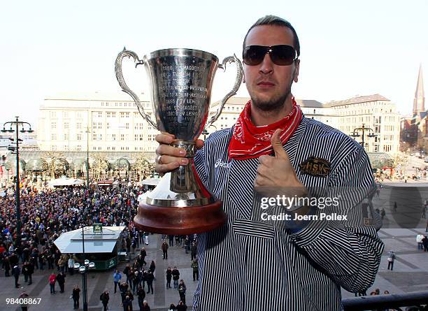 Pascal Hens of Hamburg celebrates with the cup at the Hamburg townhall after winning the DHB German Cup final match between HSV Handball and Rhein...