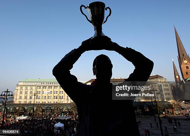 Pascal Hens of Hamburg celebrates with the cup at the Hamburg townhall after winning the DHB German Cup final match between HSV Handball and Rhein...