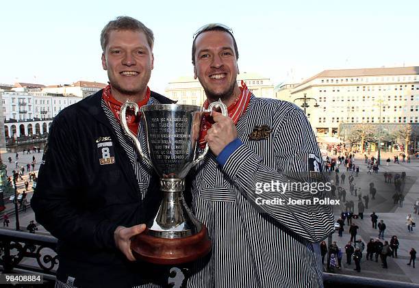 Pascal Hens and Johannes Bitter of Hamburg celebrate with the cup at the Hamburg townhall after winning the DHB German Cup final match between HSV...