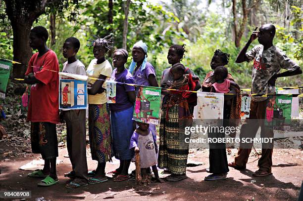 Sudanese voters queue to vote at a polling station in the outskirts of the south-central town of Yambio in southern Sudan on April 12, 2010. The...